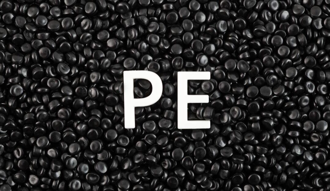 A batch of small black polyethylene granules collected together. Two white letters, "P" and "E", sit in the plastic granules.